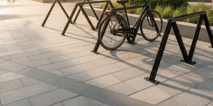 Velohawk Motu outdoor bike racks on a paved footpath with a bike parked