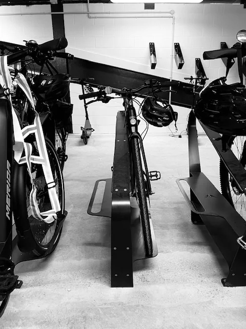 Velohawk Toa floor racks holding e-bikes in a basement bike room