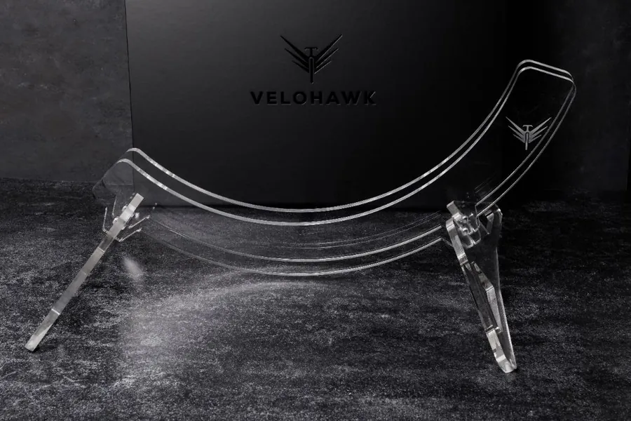 Luna clear bike stand in front of a black Velohawk backdrop