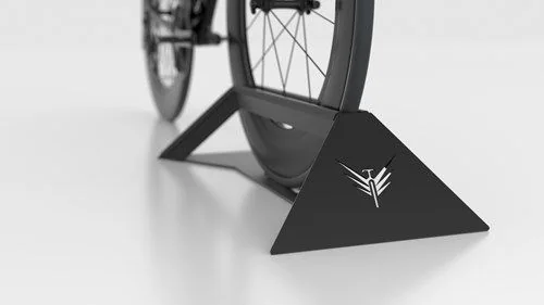 Velohawk black bike stand with rubber trim and the hawk logo, holding a road bike wheel
